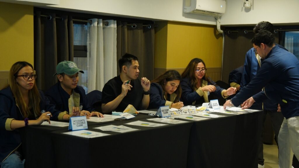 ABS team members completing a Lean Six Sigma process simulation during Yellow Belt Training.