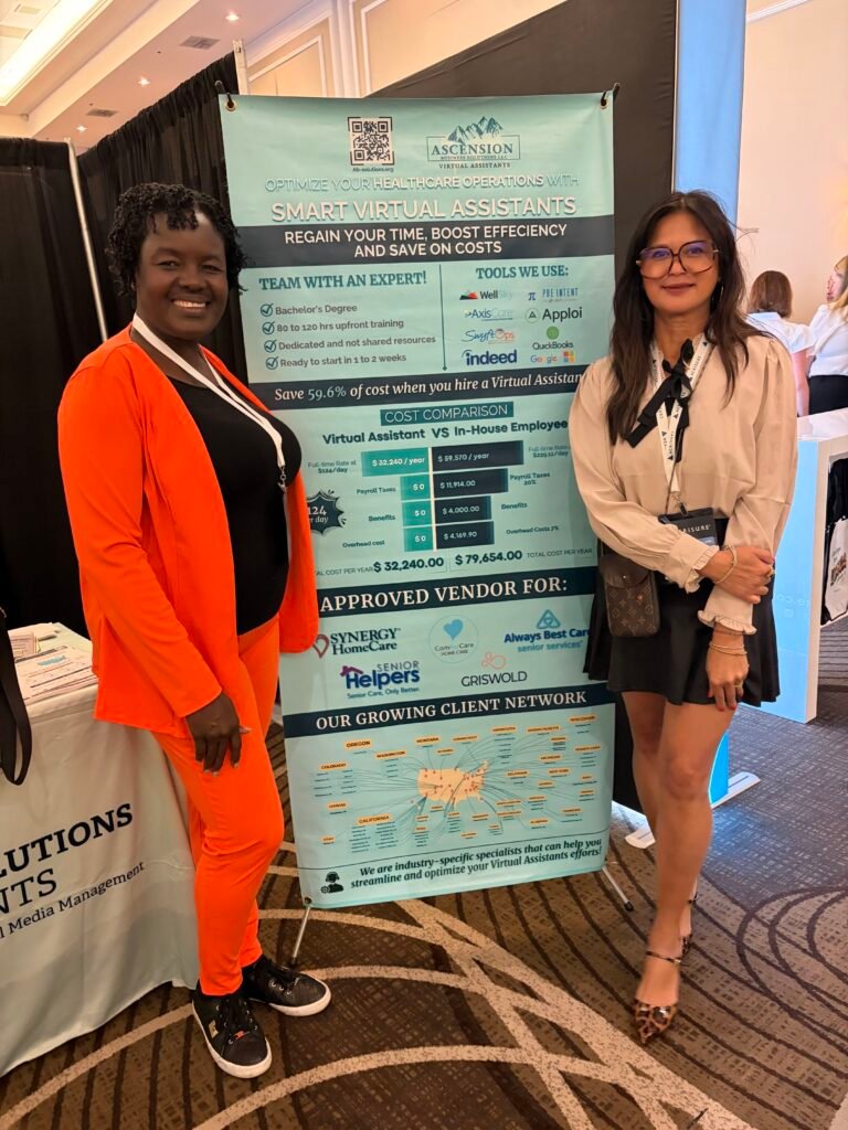 Two women pose beside an Ascension Business Solutions exhibition banner promoting specialized virtual assistant services for healthcare agencies.