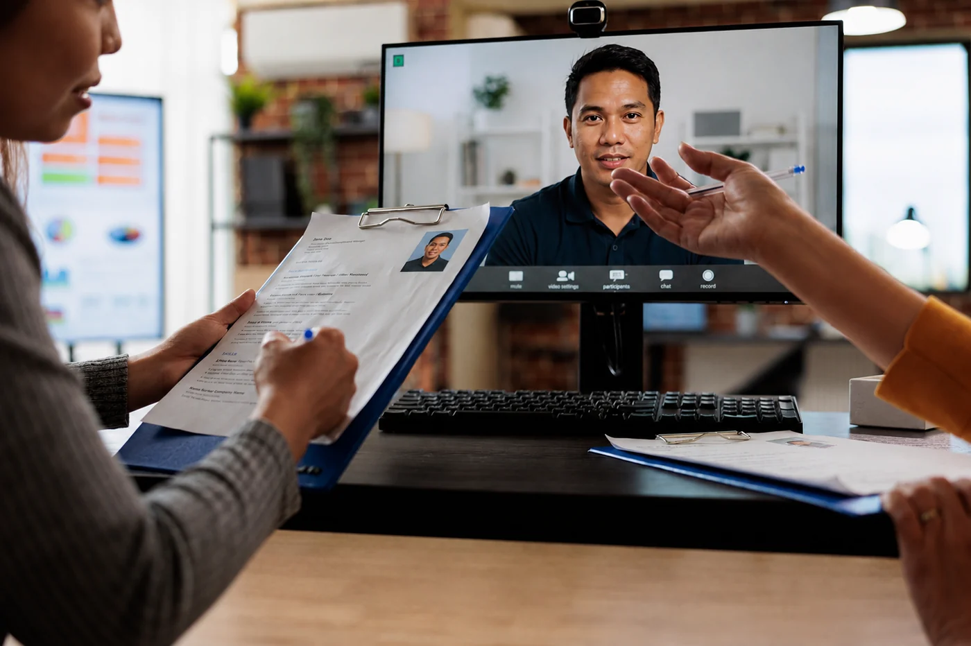 Two recruiters reviewing a candidate assessment on a video call